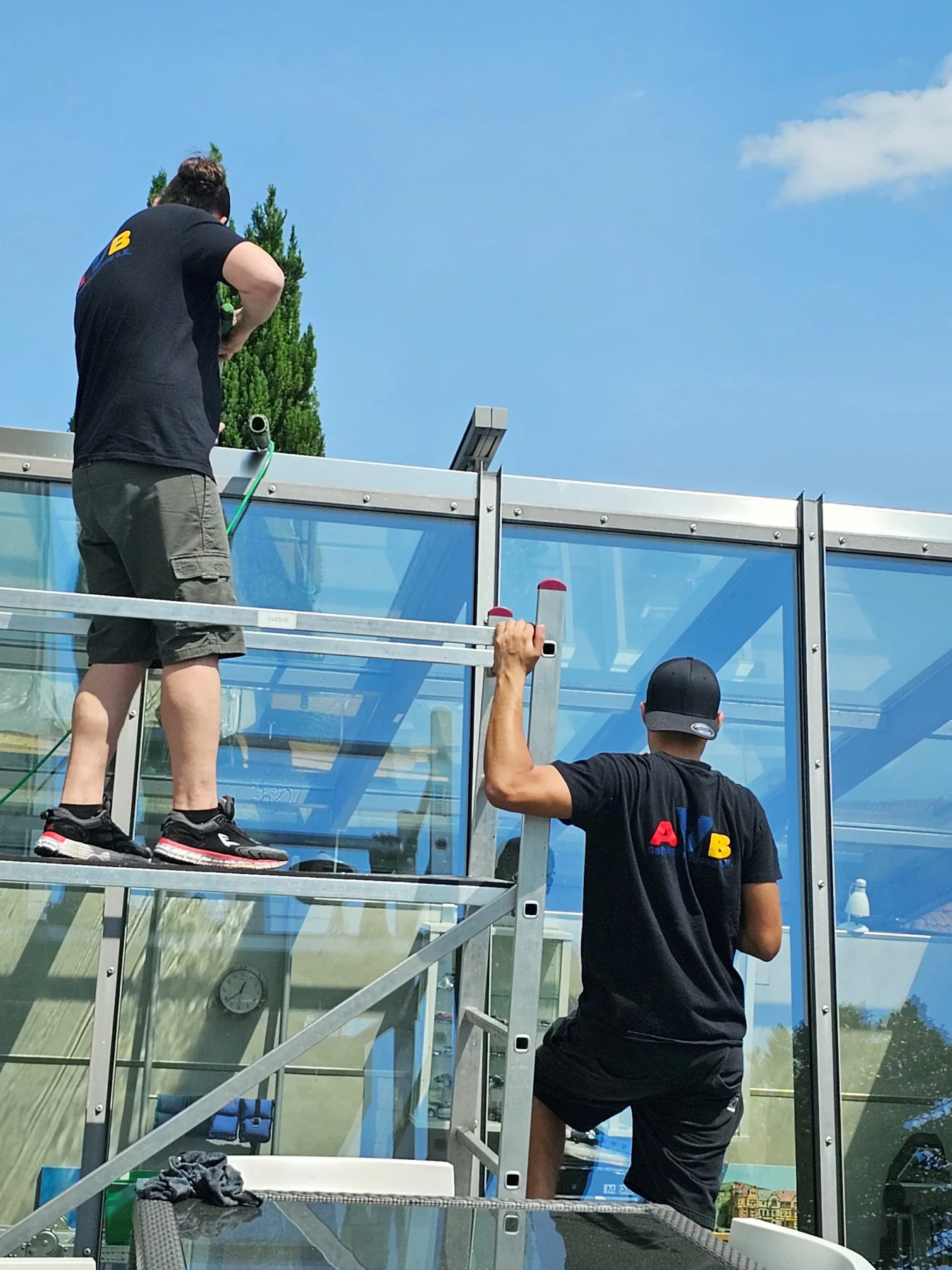 Zwei AVB-Mitarbeiter bei der Reinigung einer Glasüberdachung